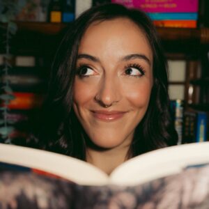lil miss saga reading lil miss saga smiling while reading a book